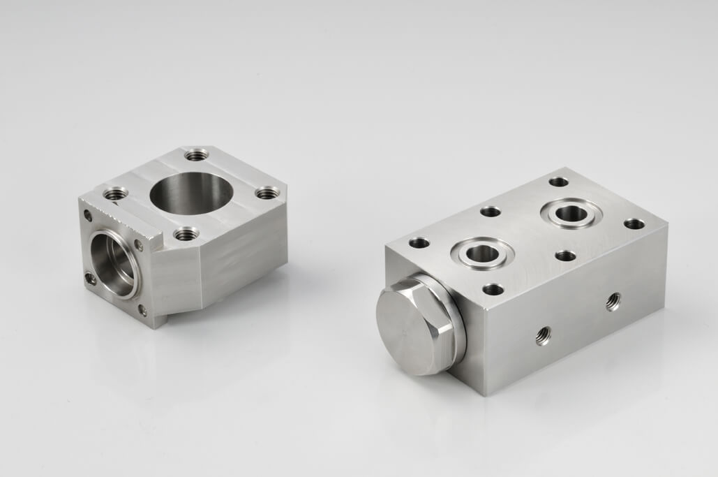 How will tighter CNC machining part tolerances impact design and production?